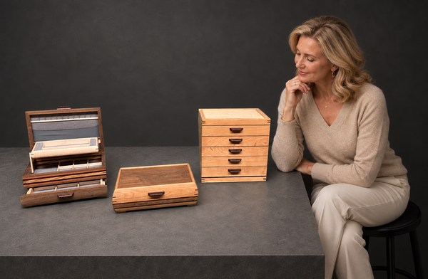 Woman admiring three handcrafted wooden jewelry boxes by Mikutowski Woodworking