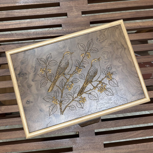 Two songbirds on a berry branch engraved on a wooden jewelry box lid