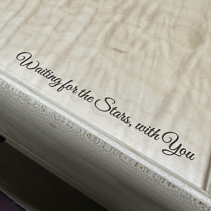 "Waiting for the Stars, with You" engraved in script on a curly maple jewelry box lid