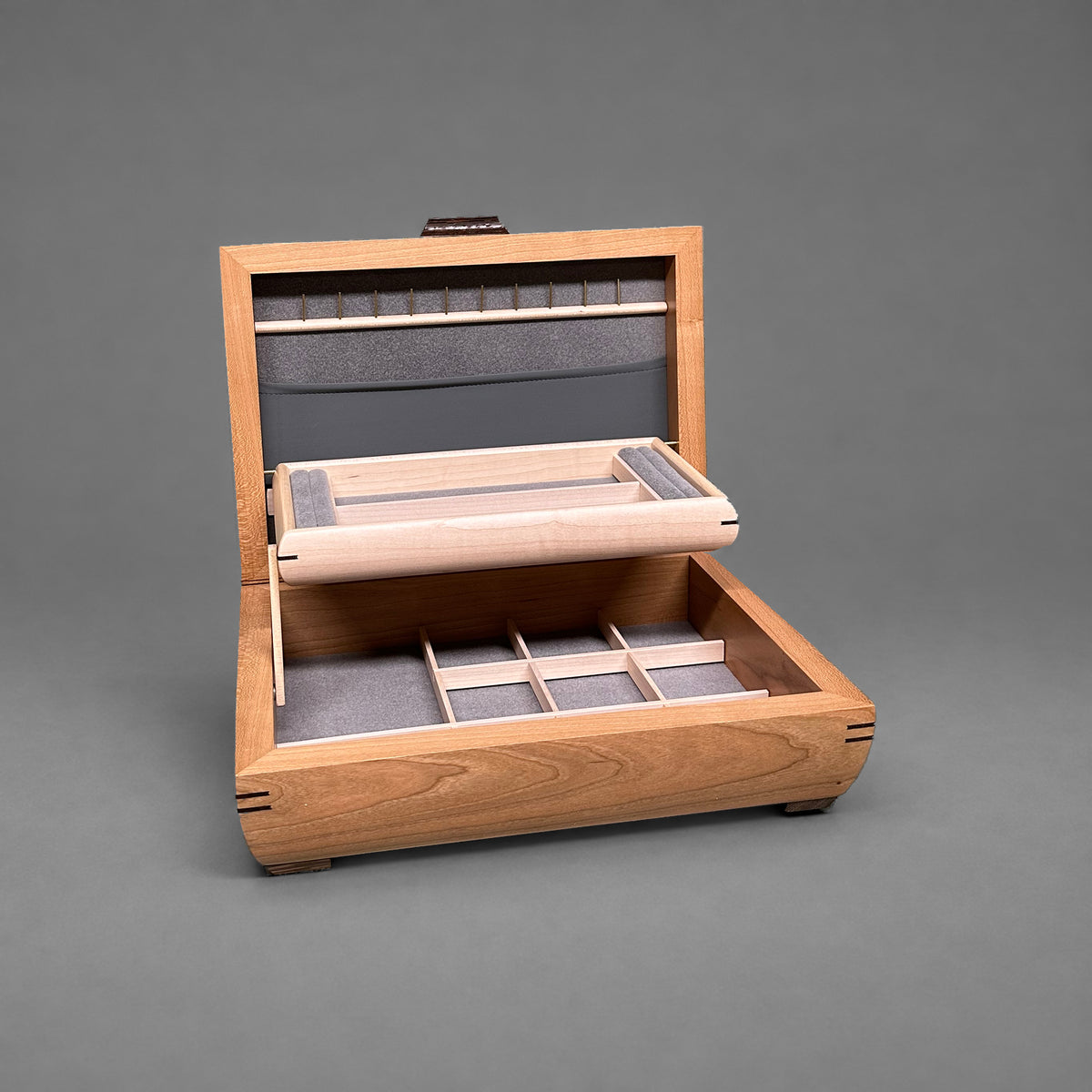 Elegance jewelry box in cherry with walnut lid, open showing the self-rising tray