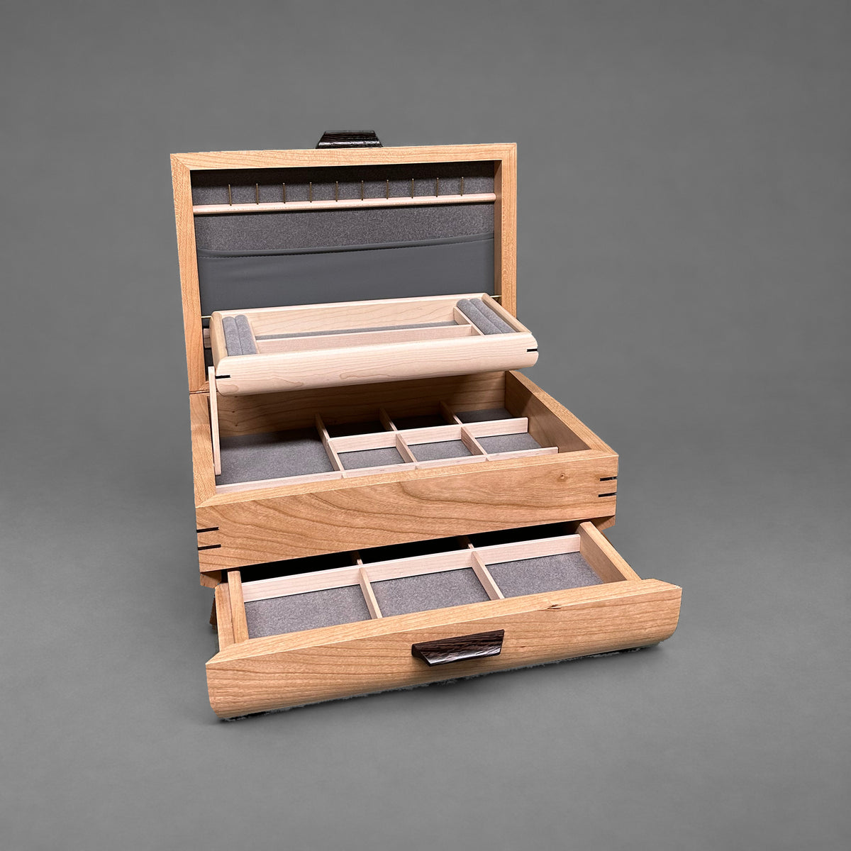 Sophisticated Jewelry Chest in cherry with walnut lid, open showing the self-rising tray and pull-out drawer