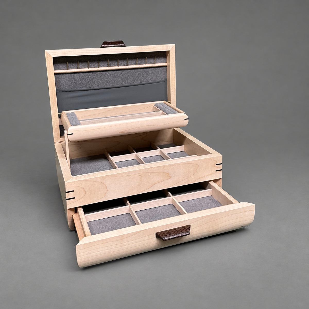Sophisticated Jewelry Chest in curly maple with walnut lid, open showing the self-rising tray and pull-out drawer