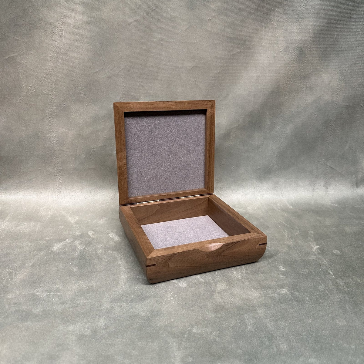 Square Trinket Box in walnut with curly maple lid, open showing soft-lined compartment and lined lid