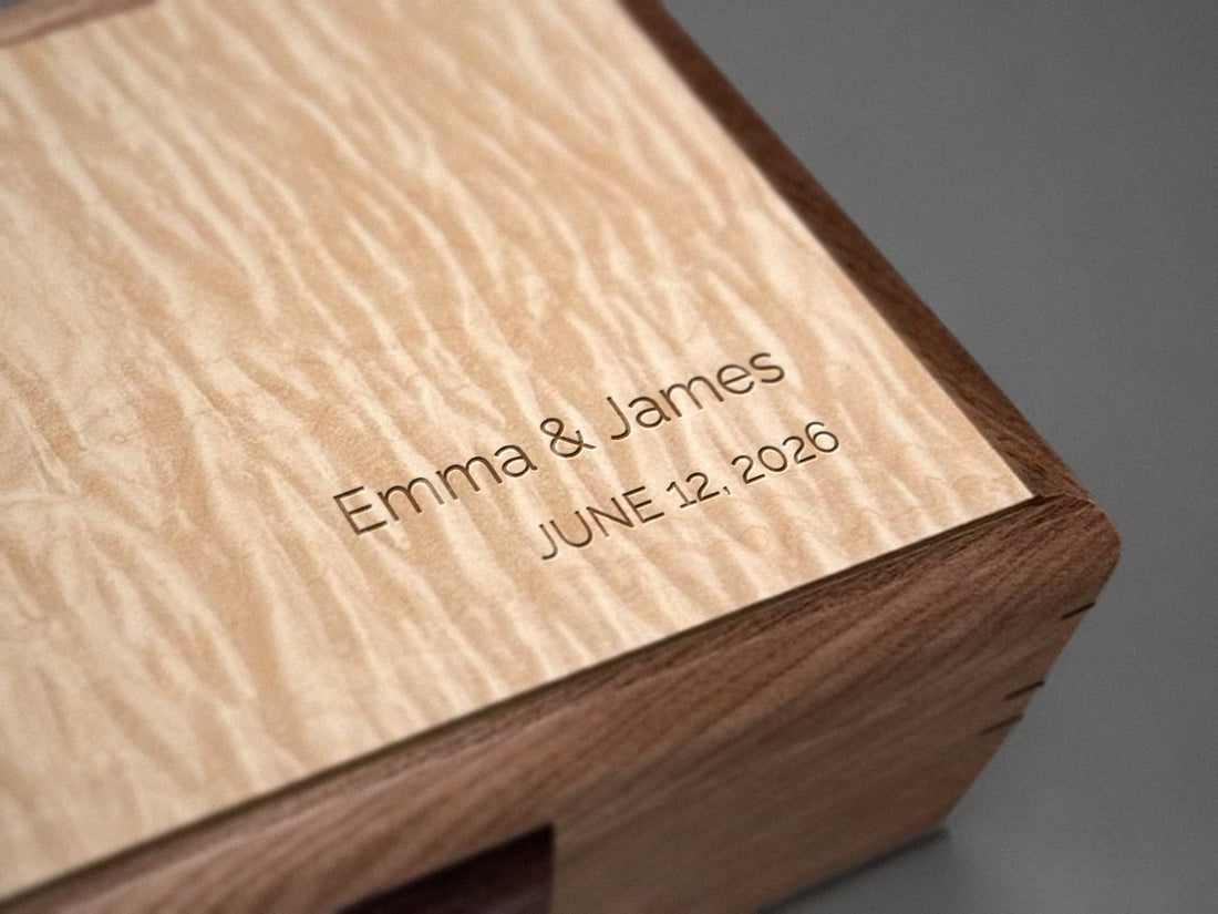Bottom-right engraving on the top of a walnut jewelry chest with a curly maple lid