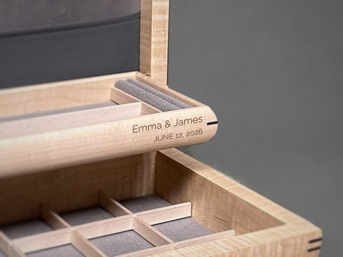 Right-aligned engraving on the front of the self-rising tray of a curly maple jewelry box