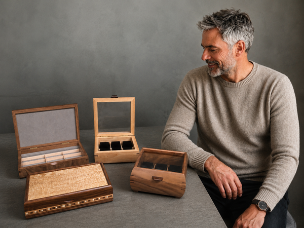 Man admiring handcrafted wooden valet boxes